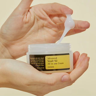 A close-up of a small amount of COSRX's Advanced Snail 92 All In One Cream being scooped reveals its rich, gel-type texture.