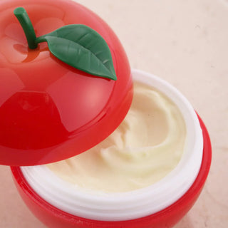 A close-up of TONYMOLY's Red Apple Hand Cream, showcasing its rich, custard-like texture.