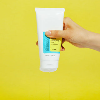 COSRX's Low pH Good Morning Gel Cleanser with the cap open. The product is being squeezed, revealing its gel texture.