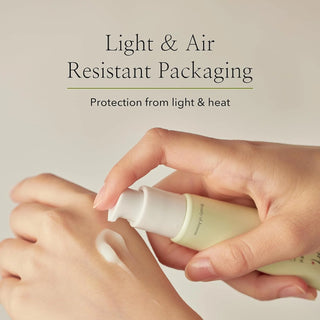 A close-up of Beauty of Joseon's Light On Serum Centella + Vita C being dispensed onto the hand shows its lightweight texture. The light and air-resistant packaging provides protection from light and heat.