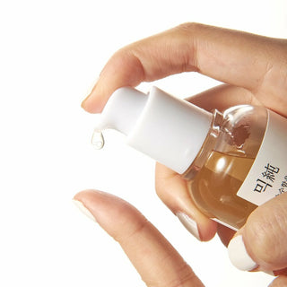 A close-up of mixsoon's Bean Essence being dispensed from the pump.
