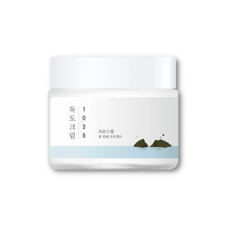 ROUND LAB's 1025 Dokdo Cream comes in a clear jar with a white lid.