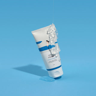 ROUND LAB's Birch Juice Moisturizing Cleanser with gel texture dripping onto the top of the tube.