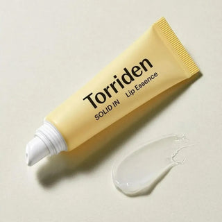 Torriden's SOLID IN Ceramide Lip Essence with the cap off, showing a swatch of the gel-like texture.