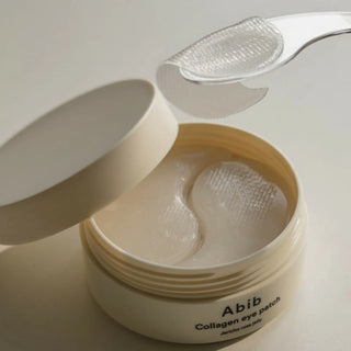 A close-up of Abib's Collagen Eye Patch Jericho Rose Jelly patches. Use the included spatula to lift the eye patch.