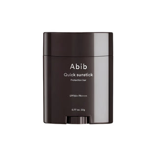 Abib's Quick Sunstick Protection Bar SPF 50+ PA++++ in a 22g (0.77 oz) twist-up design. The product is curved and wide with dark brown packaging and a matching cap.