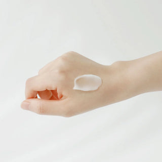 A close-up of Beauty of Joseon's Apricot Blossom Peeling Gel on the model's hand, revealing a gel-like texture.
