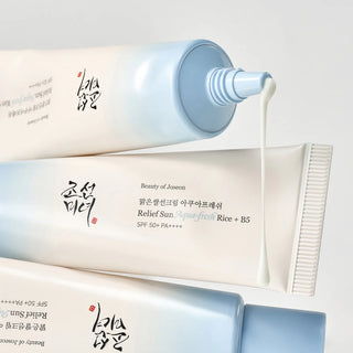 A closeup of Beauty of Joseon's Relief Sun Aqua-Fresh: Rice + B5 SPF50+ PA++++ with the nozzle exposed, revealing the lightweight, lotion-like watery sunscreen being dispensed.