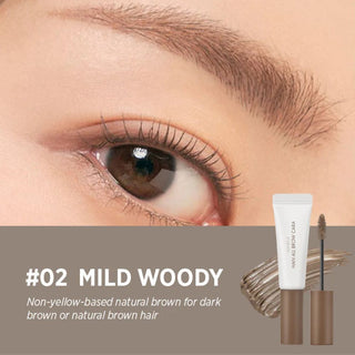 Close-up of a model’s eye and eyebrow with rom&nd's Han All Brow Cara Brow Gel in Mild Woody applied. The gel provides a non-yellow based natural brown, ideal for dark brown or natural brown hair. The image also includes a swatch of the product and the actual product.